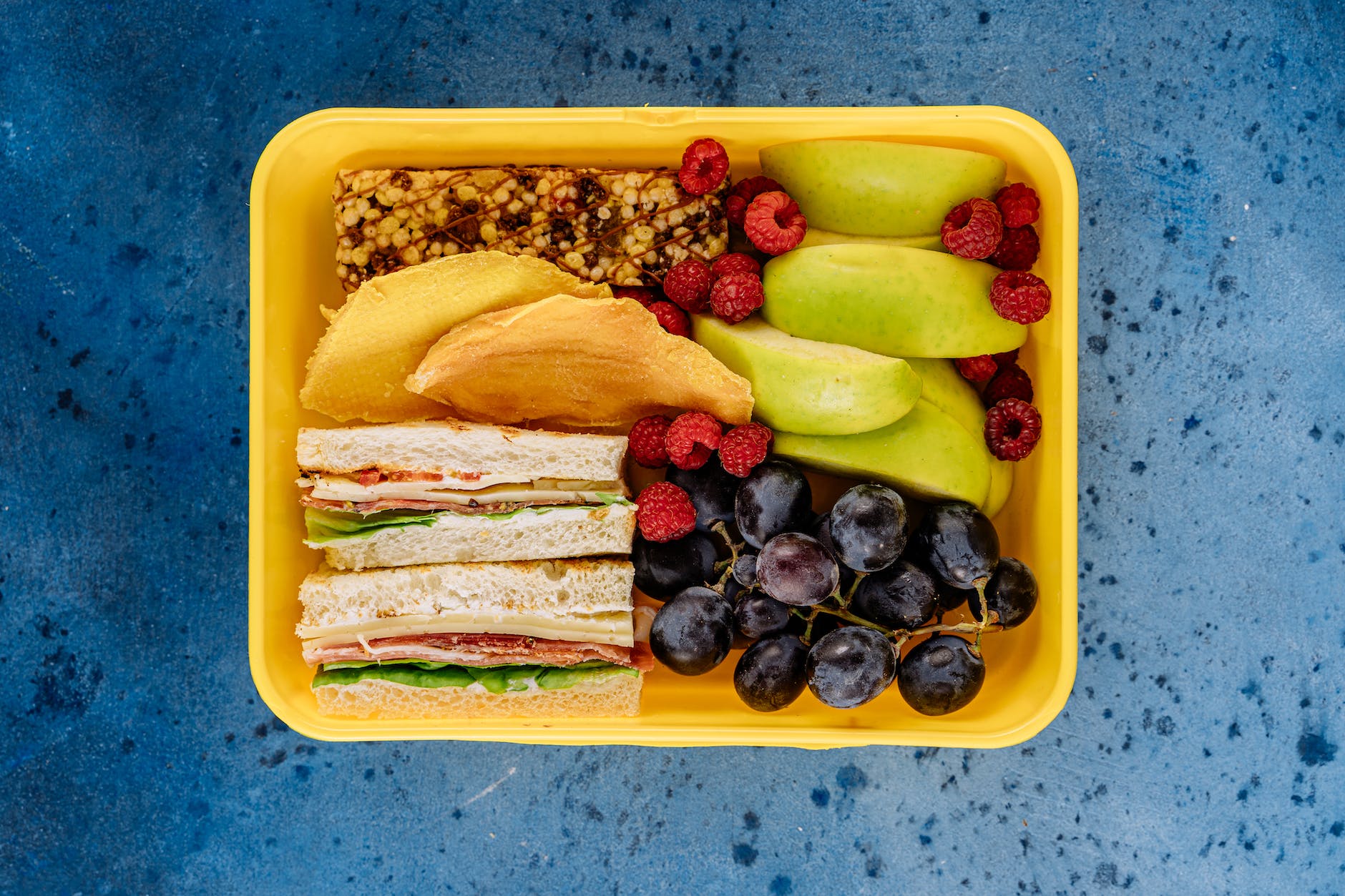 lunch box with fruit and sandwiches