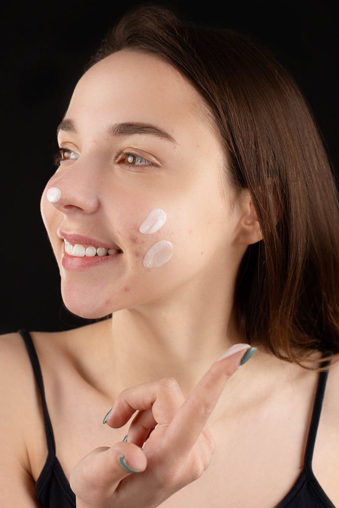 woman applying facial cream